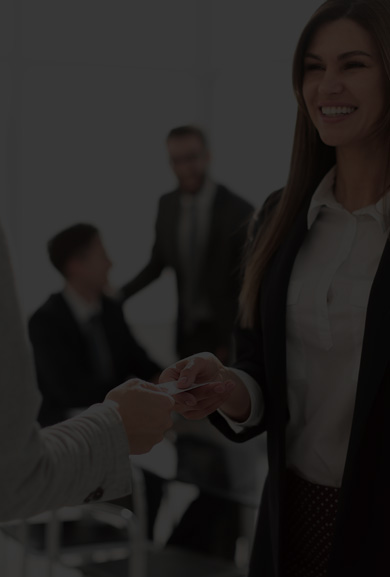 Business Woman handing business card to another professional